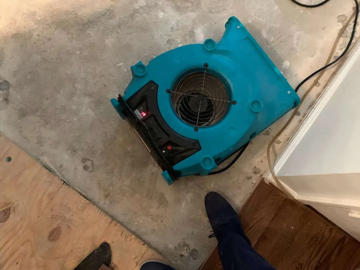 Air mover drying subfloor during Commercial Water Damage Restoration in Monroe